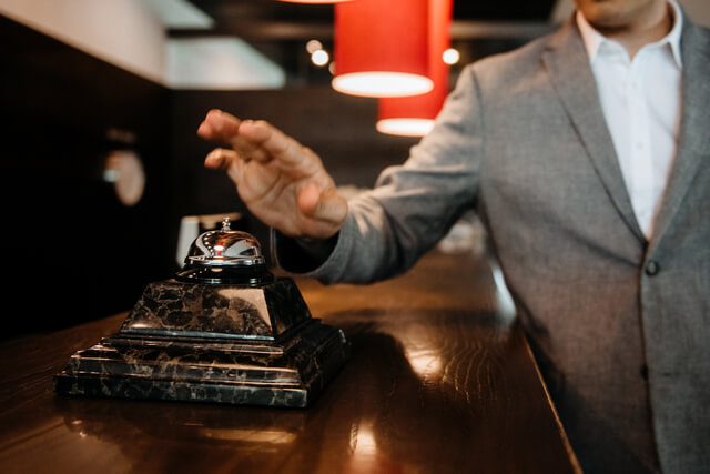 small-vecteezy_t-the-guy-clicks-on-the-bell-at-the-reception-of-the-hotel_2919869_small